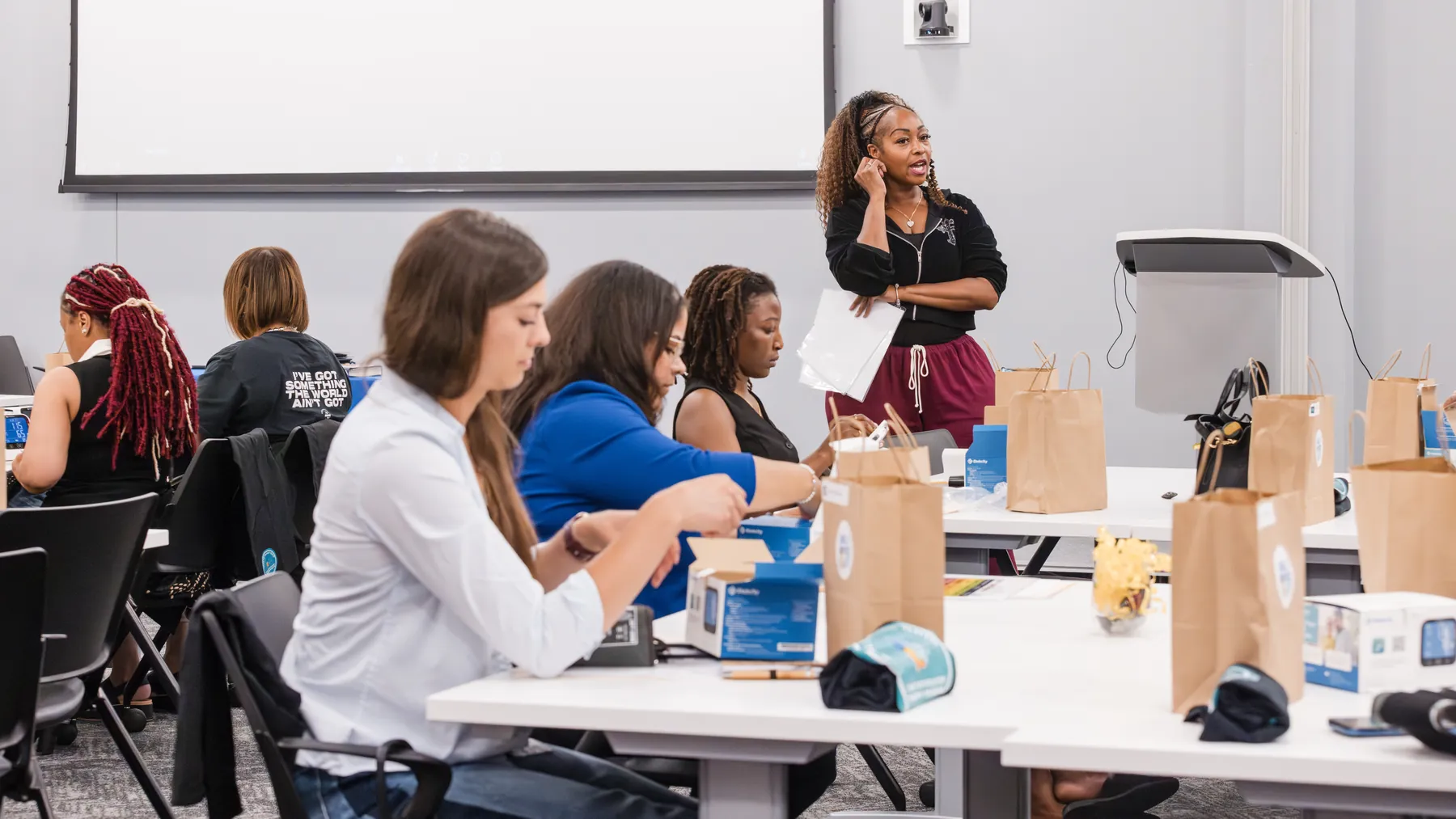Facilitator speaking to participants during a community health workshop, documented by Dwain Thomas Photography